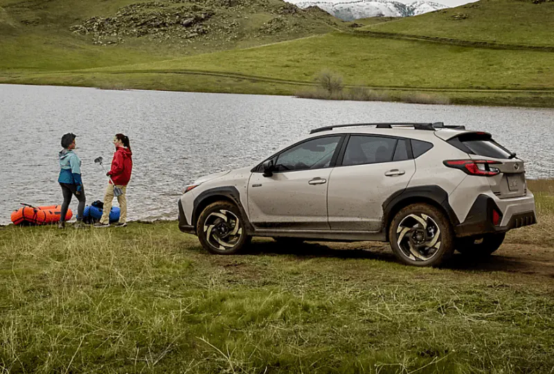 Preowned silver Subaru Crosstrek by a lake