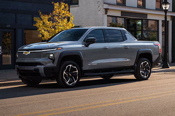 Gray 2025 Chevrolet Silverado EV driving along city streets