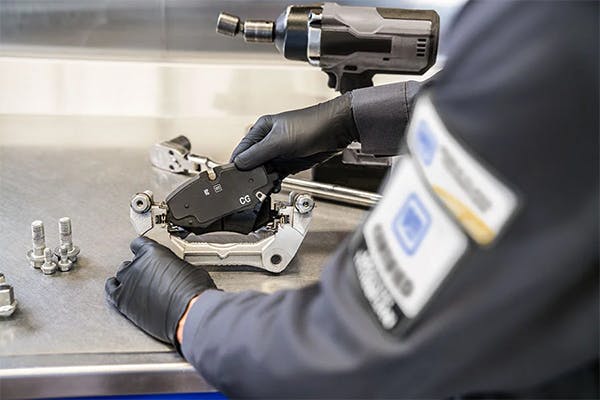 service technician performing calibration on brake components