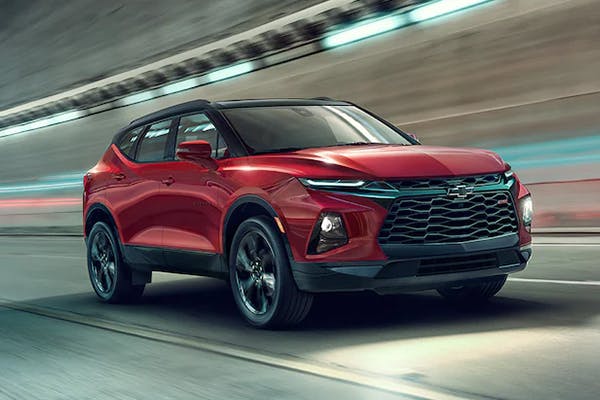 Red Chevrolet vehicle driving through a tunnel