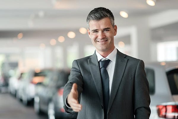 smiling business man extending their hand to greet