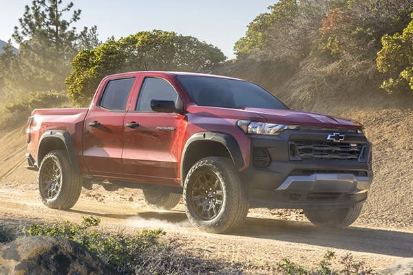 red chevrolet truck driving off-road