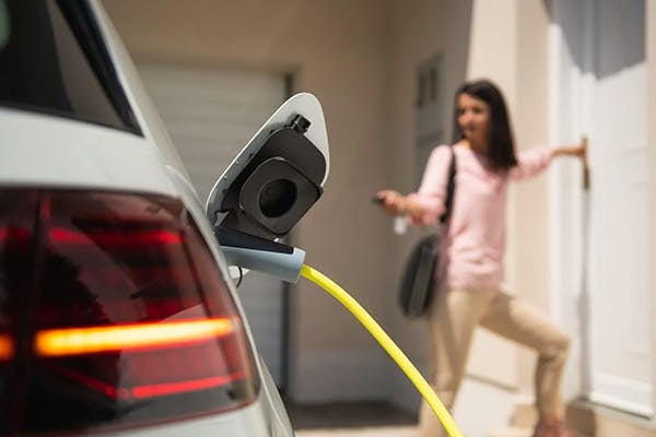 Electric vehicle plugged in outside own house while owner locks the doors