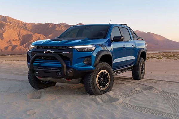 Blue Chevrolet Colarado on sand