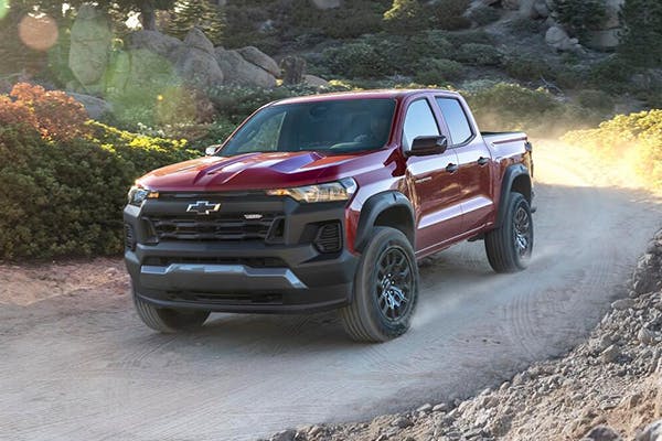 Red Chevrolet vehicle driving through a tunnel