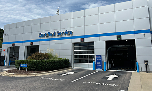 Certified Service Technician adjusting a wheel