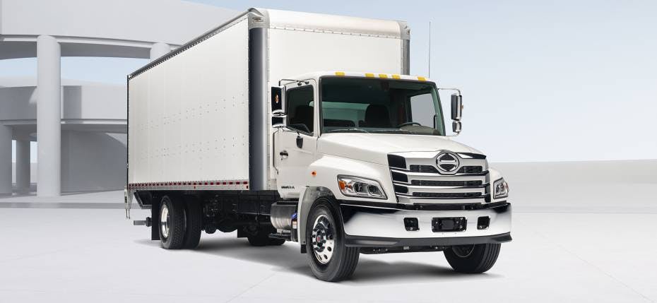 A white Hino L Series truck 