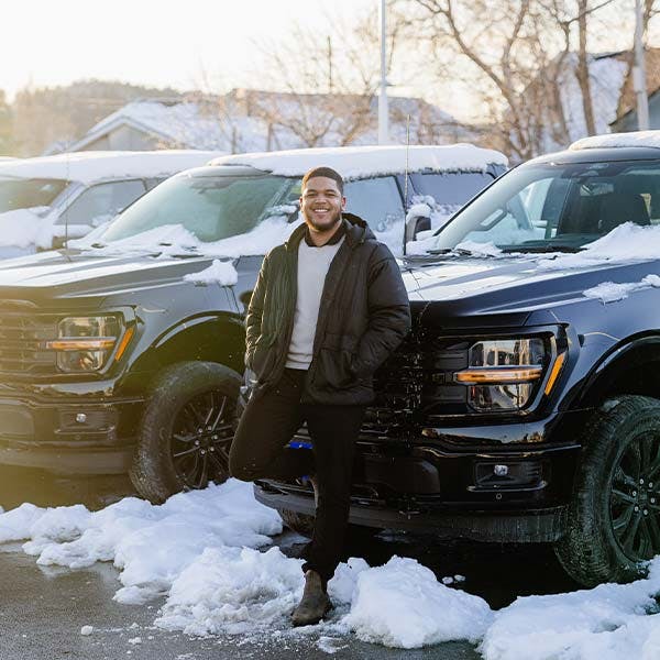 A man standing in front of an SUV
