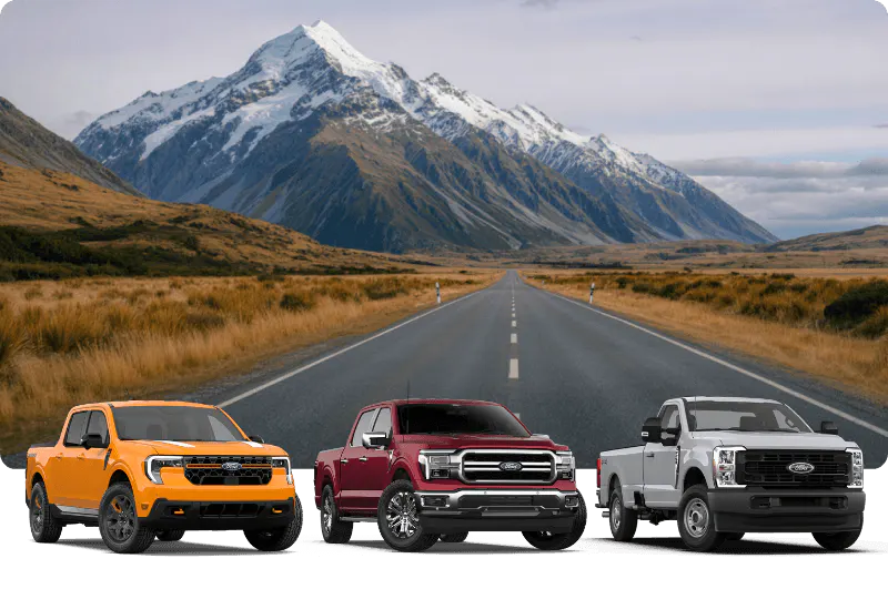 Three Ford trucks — Maverick, F-150, and Super Duty, lined up on a mountain road
