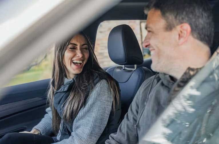 happy couple inside a vehicle