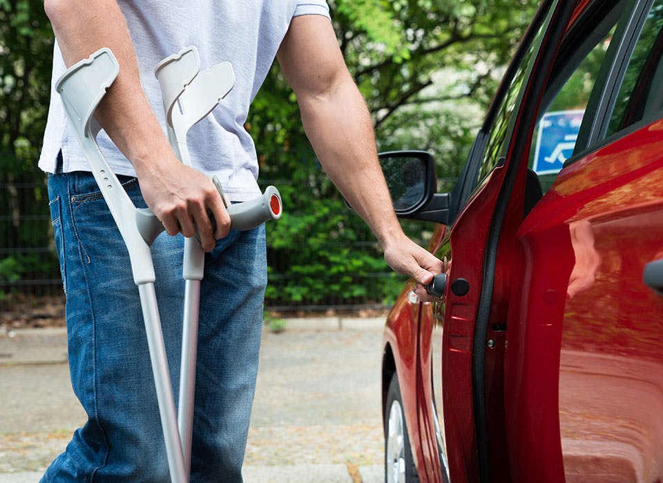 Disabled man getting into car