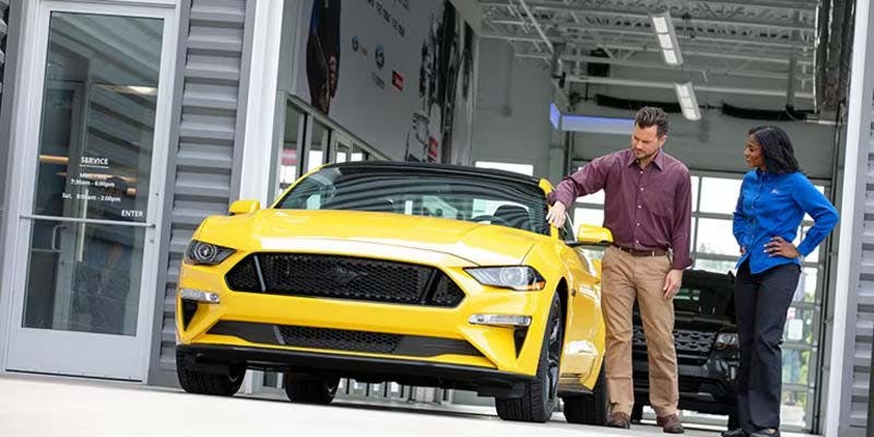 a yellow ford vehicle in a ford repair shop