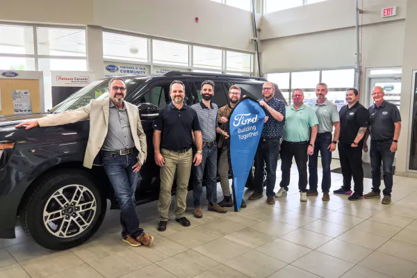 The cypress motors siwft current team posing in the dealership
