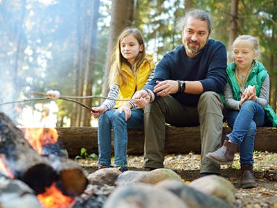 father and daughters camping