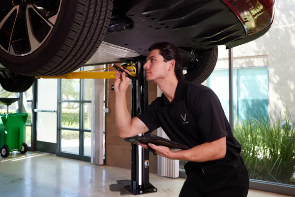 technician checking underneath Vinfast car
