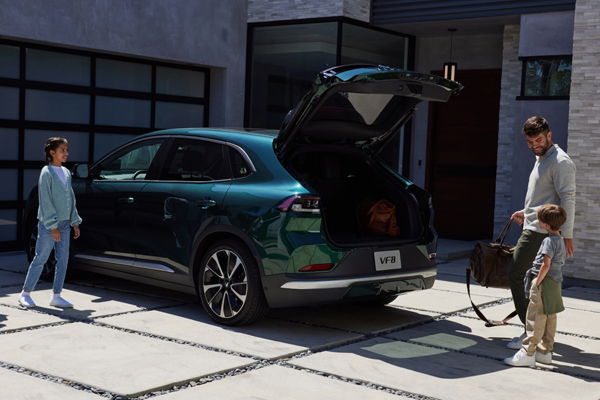 Father with children loading up the trunk of their VinFast