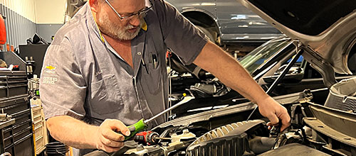 Strosnider Chevrolet Technician Working on a vehicle