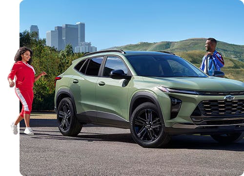 man and woman standing near their chevrolet SUV