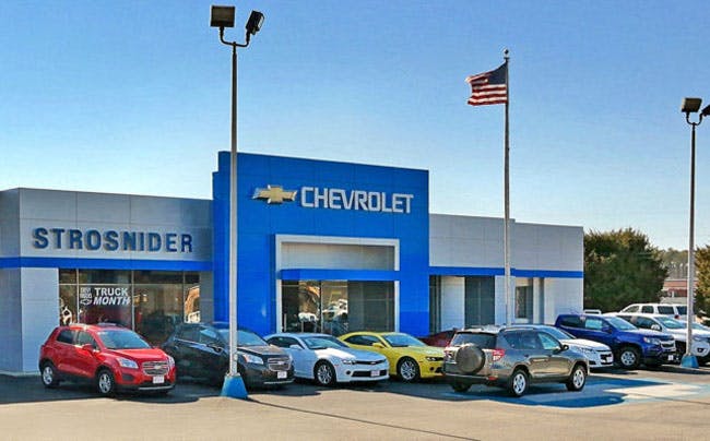 exterior of the Strosnider Chevrolet dealership with Chevy vehicles on the lot