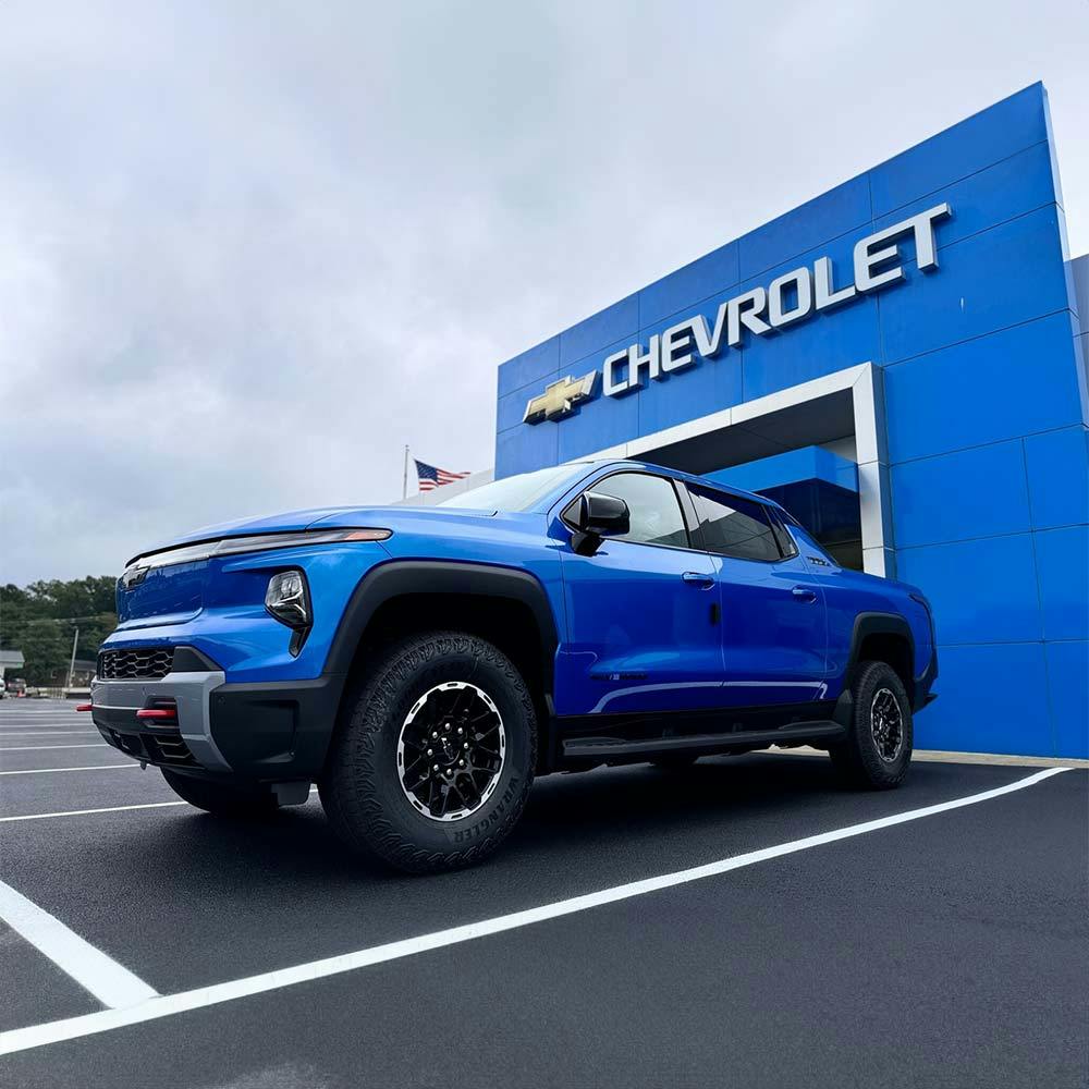exterior strosnider chevrolet dealership showcasing a blue chevy pickup