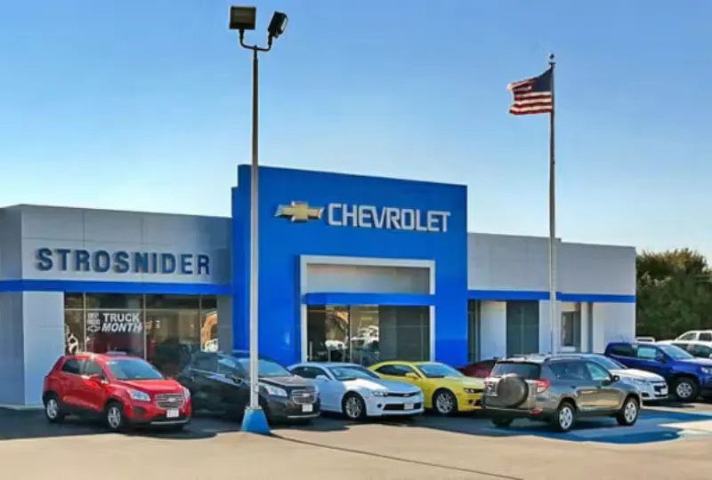 exterior of the Strosnider Chevrolet dealership with Chevy vehicles on the lot