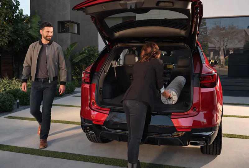 A couple loading stuff to a car trunk