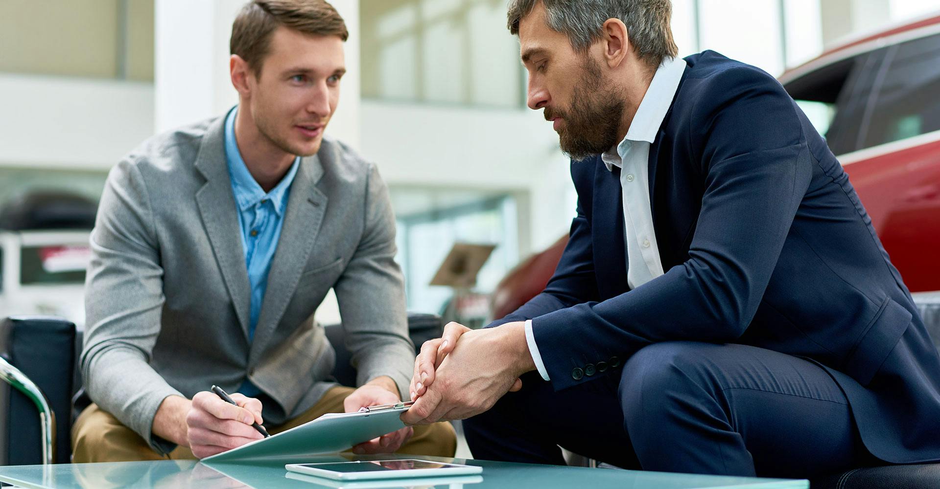 Man at a dealership talking to a salesman