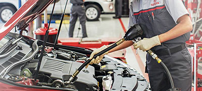 Toyota mechanic changing oil