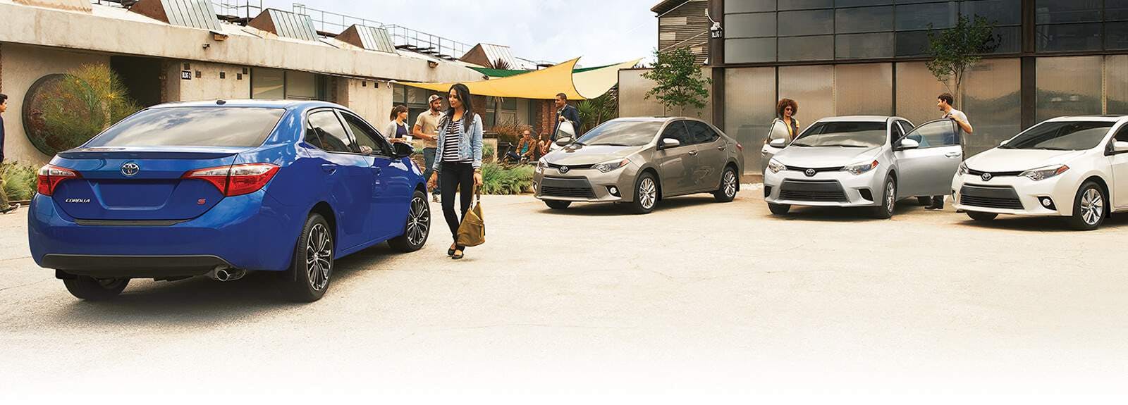 Young people looking at Toyotas