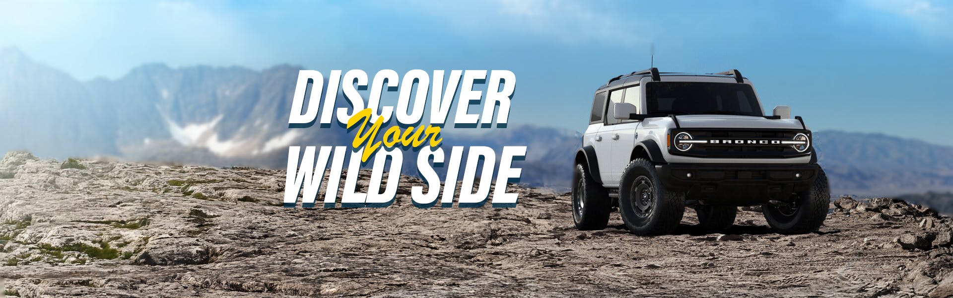 white 2025 ford brocnco on offroad terrain with text discover your wildside