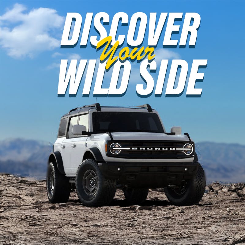 white 2025 ford brocnco on offroad terrain with text discover your wildside